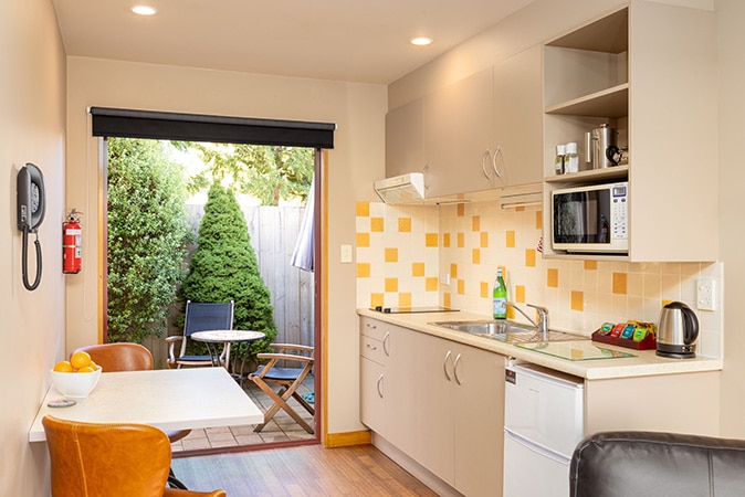 Kitchen and patio of ground floor 1 bedroom spa suite at Settlers Boutique Motel - Hanmer Springs luxury accommodation