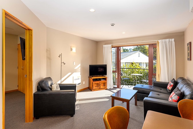 Living area of triple bedroom room at Settlers Boutique Motel - Hanmer Springs luxury accommodation